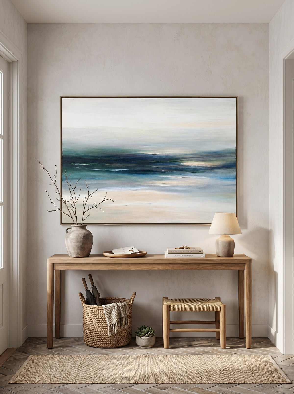 Serene teal sea and sand abstract canvas painting mounted above minimalist console table in entryway