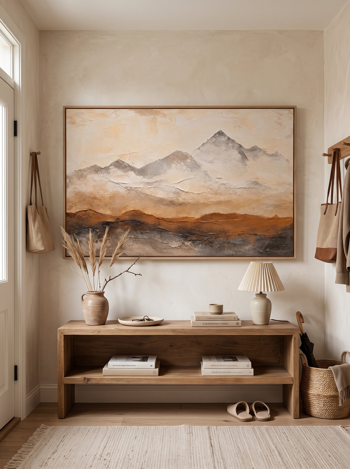 Abstract mountain painting with beige, rust and charcoal textures displayed in a modern organic entryway.