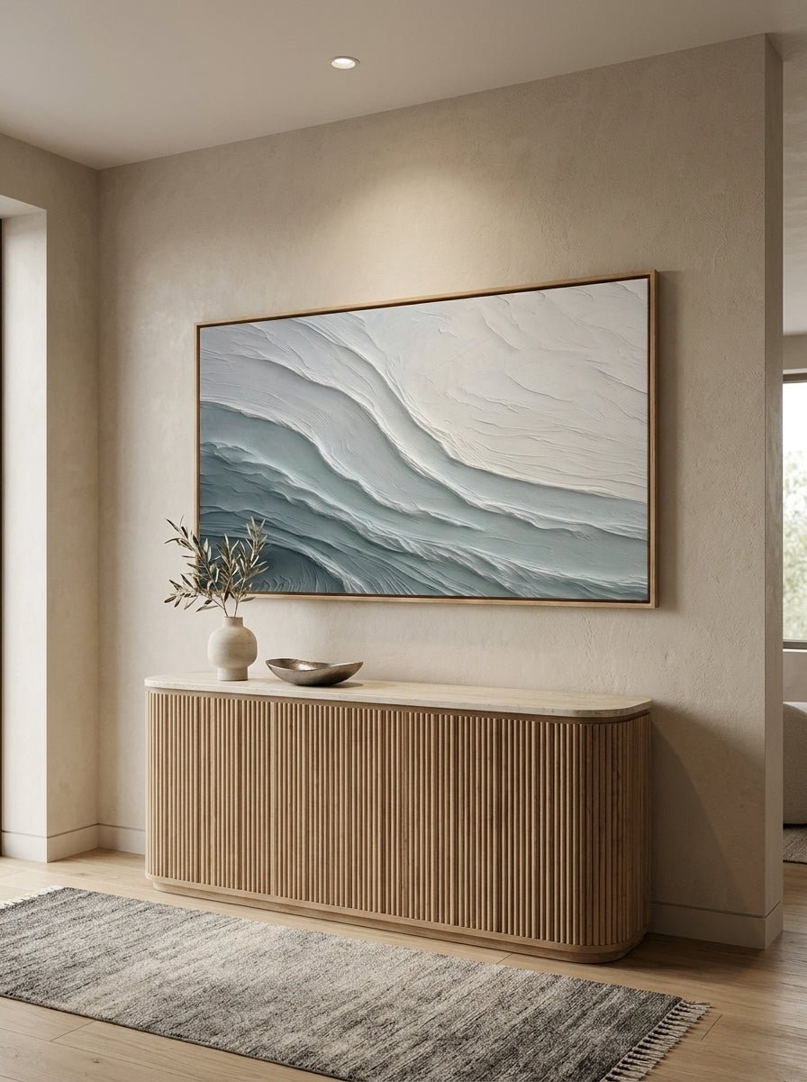 Panoramic ocean wave textured wall art placed above an entry console table with floating wood frame