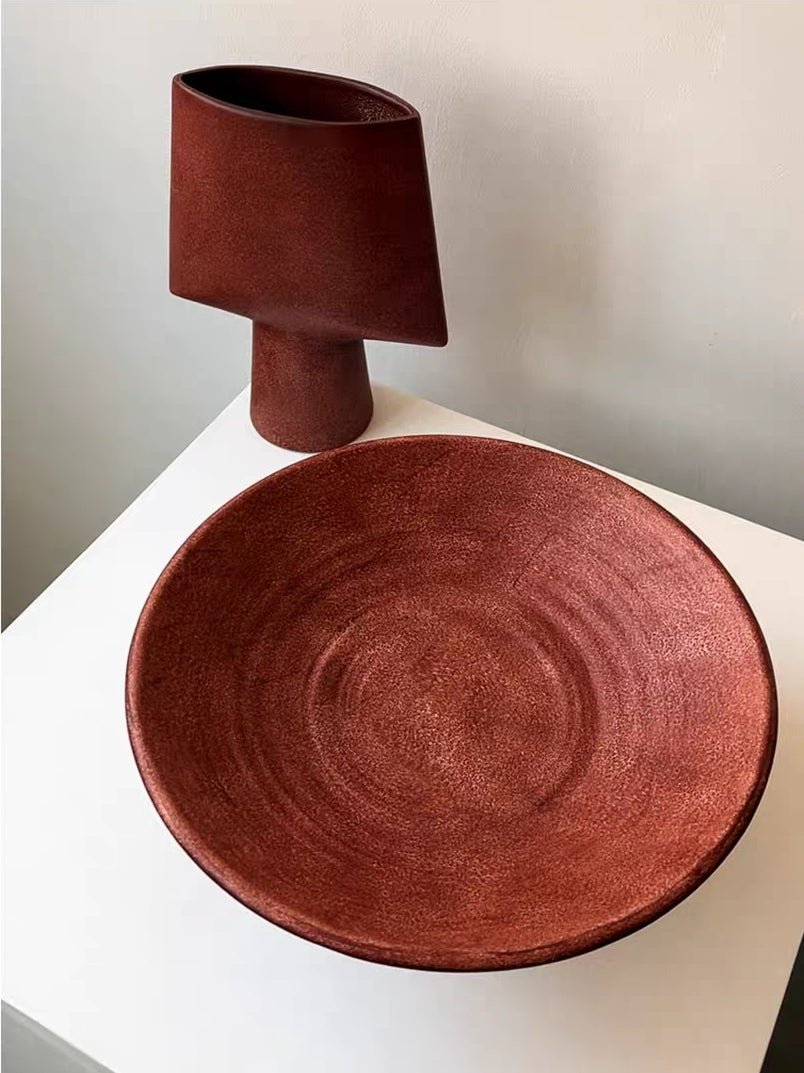 artisan ceramic geometric sculptures in matte rust red and black, modern minimalist architectural home decor on a white background.