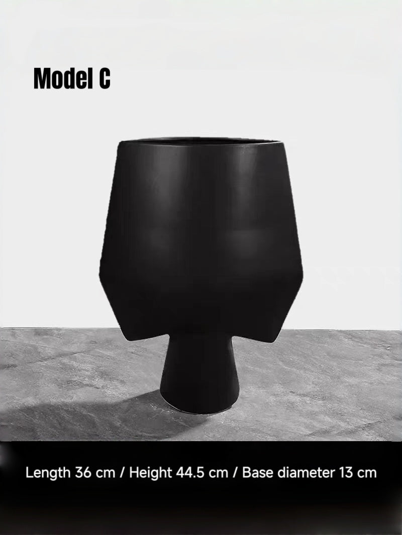 artisan ceramic geometric sculptures in matte rust red and black, modern minimalist architectural home decor on a white background.