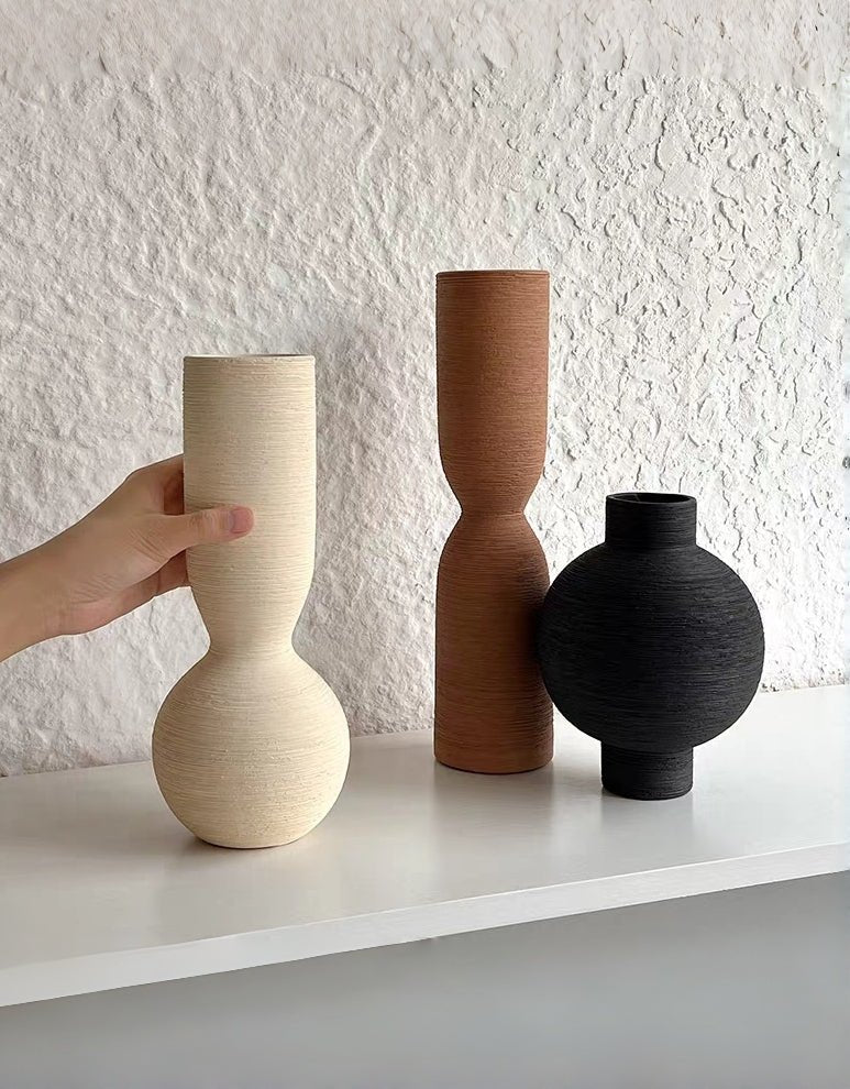 ribbed geometric ceramic vases in black, sand, and terracotta, minimalist organic pottery for shelf styling.