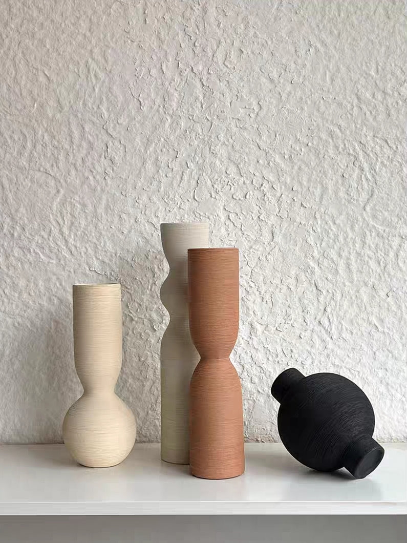 ribbed geometric ceramic vases in black, sand, and terracotta, minimalist organic pottery for shelf styling.