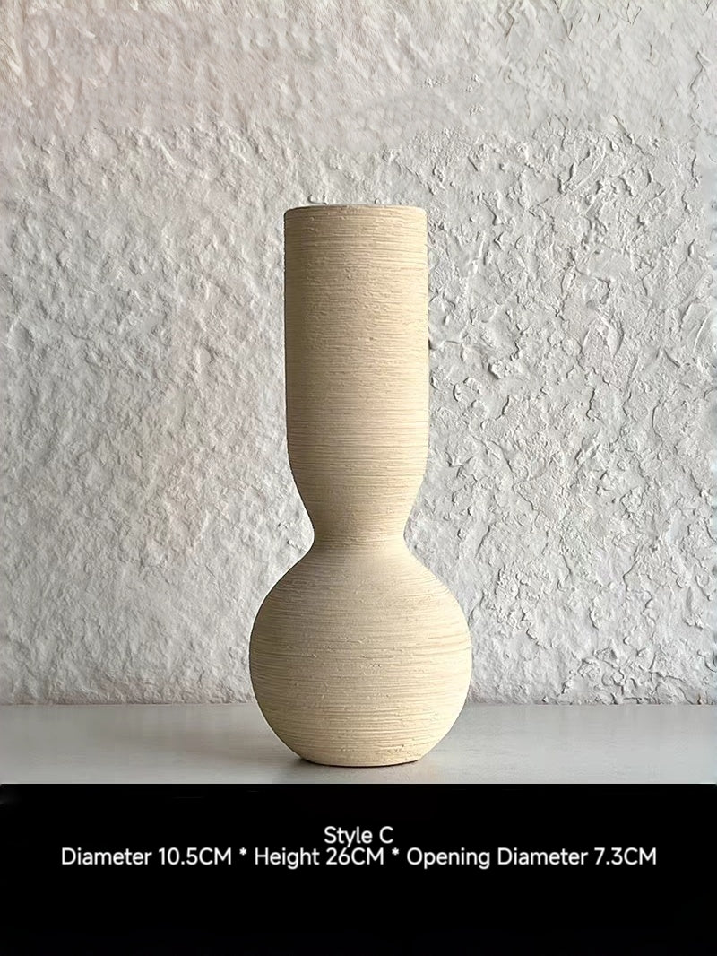 ribbed geometric ceramic vases in black, sand, and terracotta, minimalist organic pottery for shelf styling.