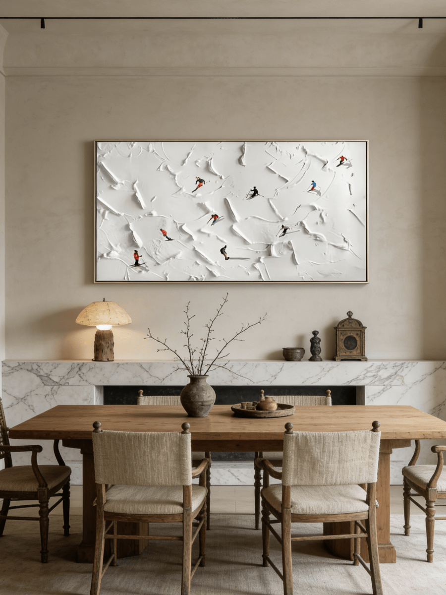 Close-up of large 3D textured painting by Lucien Hoffmann featuring tiny colorful skiers on a heavy white impasto snow mountain canvas.