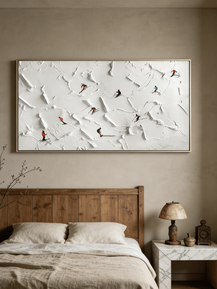 Close-up of large 3D textured painting by Lucien Hoffmann featuring tiny colorful skiers on a heavy white impasto snow mountain canvas.