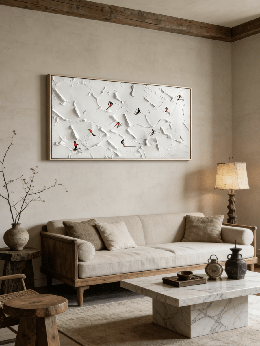 Close-up of large 3D textured painting by Lucien Hoffmann featuring tiny colorful skiers on a heavy white impasto snow mountain canvas.