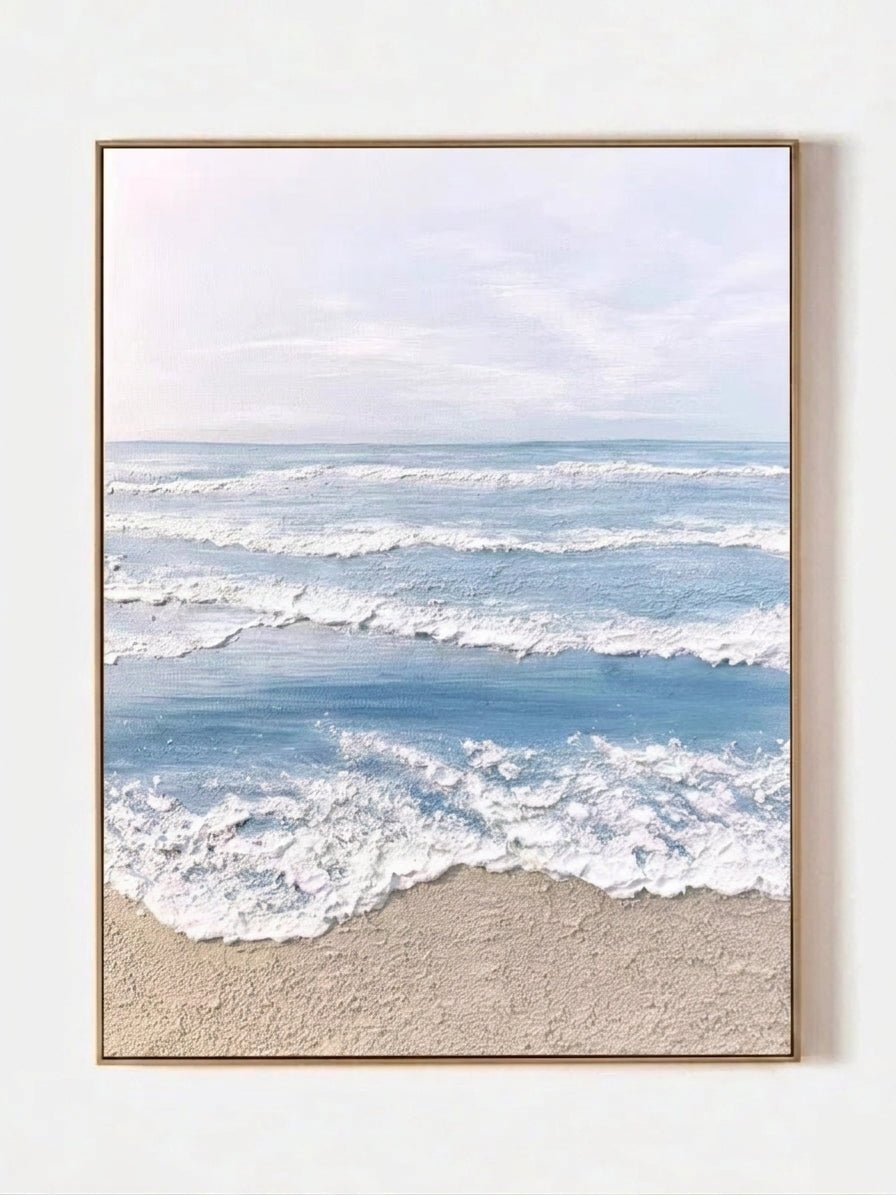 Hand painted coastal ocean wave wall art with textured beach canvas in soft blue and beige tones for modern living room decor