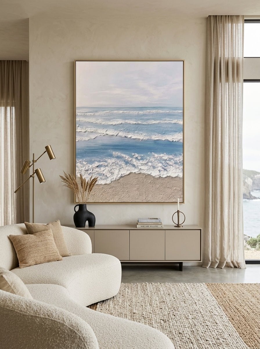Hand painted coastal ocean wave wall art with textured beach canvas in soft blue and beige tones for modern living room decor