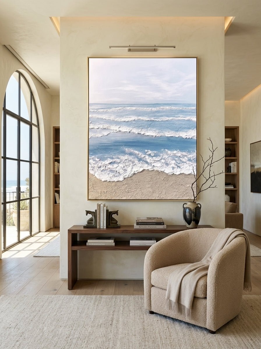 Hand painted coastal ocean wave wall art with textured beach canvas in soft blue and beige tones for modern living room decor