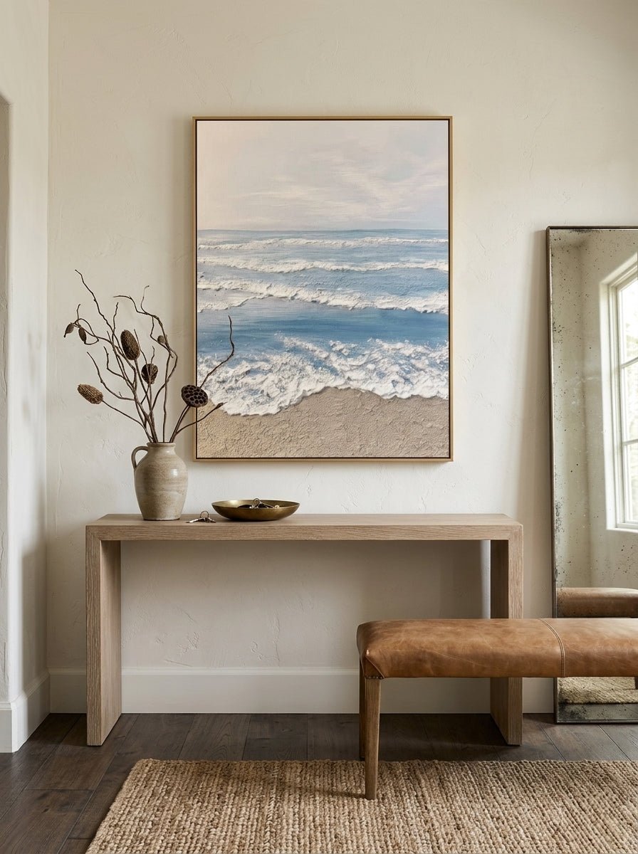 Hand painted coastal ocean wave wall art with textured beach canvas in soft blue and beige tones for modern living room decor