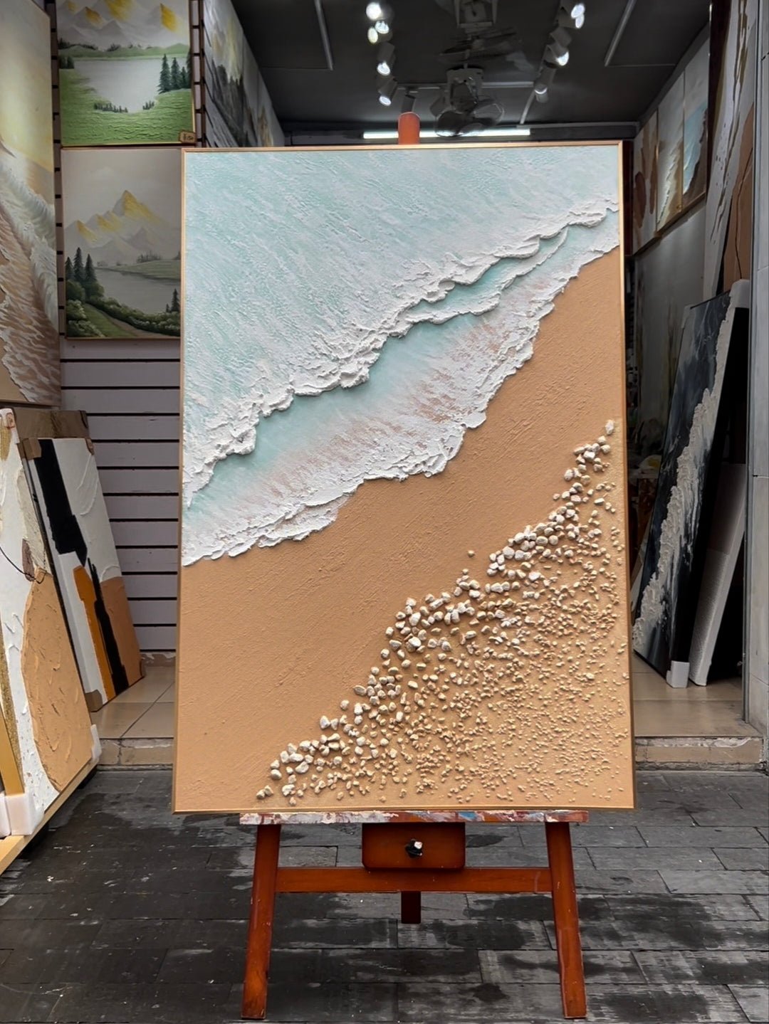 Large hand-painted 3D textured ocean beach canvas painting with sculpted waves and pebbles by Leo Liang for coastal living room decor.