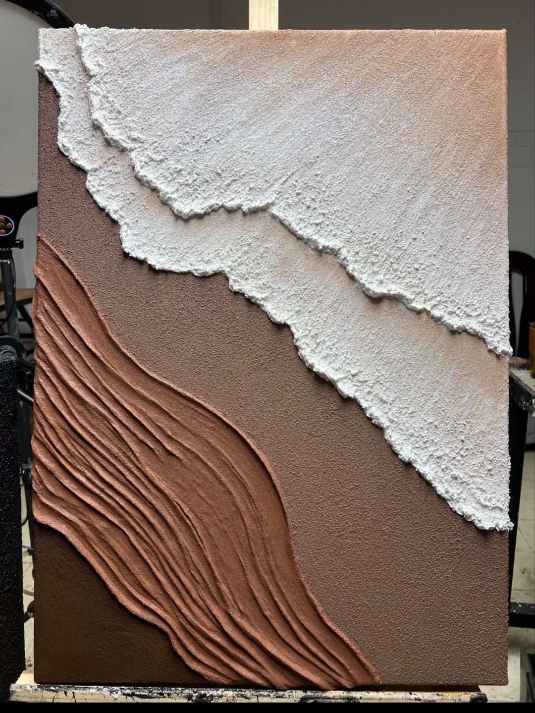 Close-up of heavy textured 3D abstract hand-painting in terracotta and white tones, showcasing impasto technique by Leo Liang for modern living room decor.