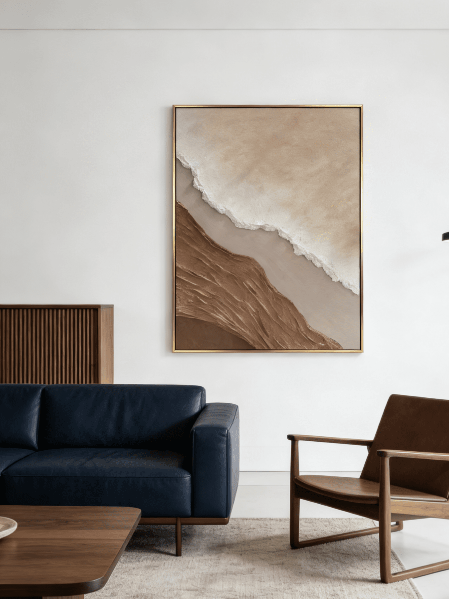 Close-up of a hand-painted 3D textured abstract beach painting featuring heavy wave-like ridges in sand beige and ochre in a gold frame.