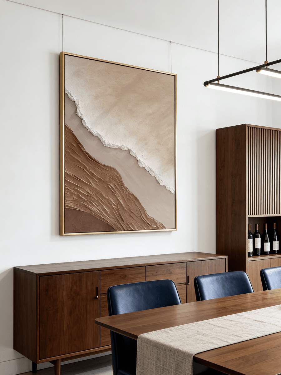 Close-up of a hand-painted 3D textured abstract beach painting featuring heavy wave-like ridges in sand beige and ochre in a gold frame.