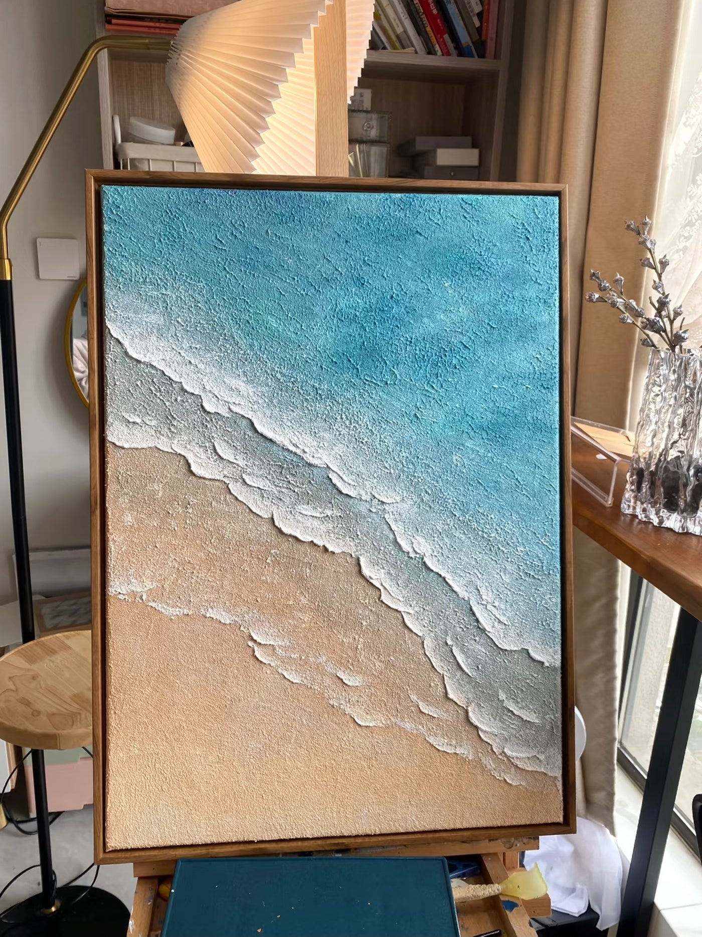 Hand-painted 3D textured beach painting with thick white sculpted seafoam ridges and deep blue water in a gold floater frame.