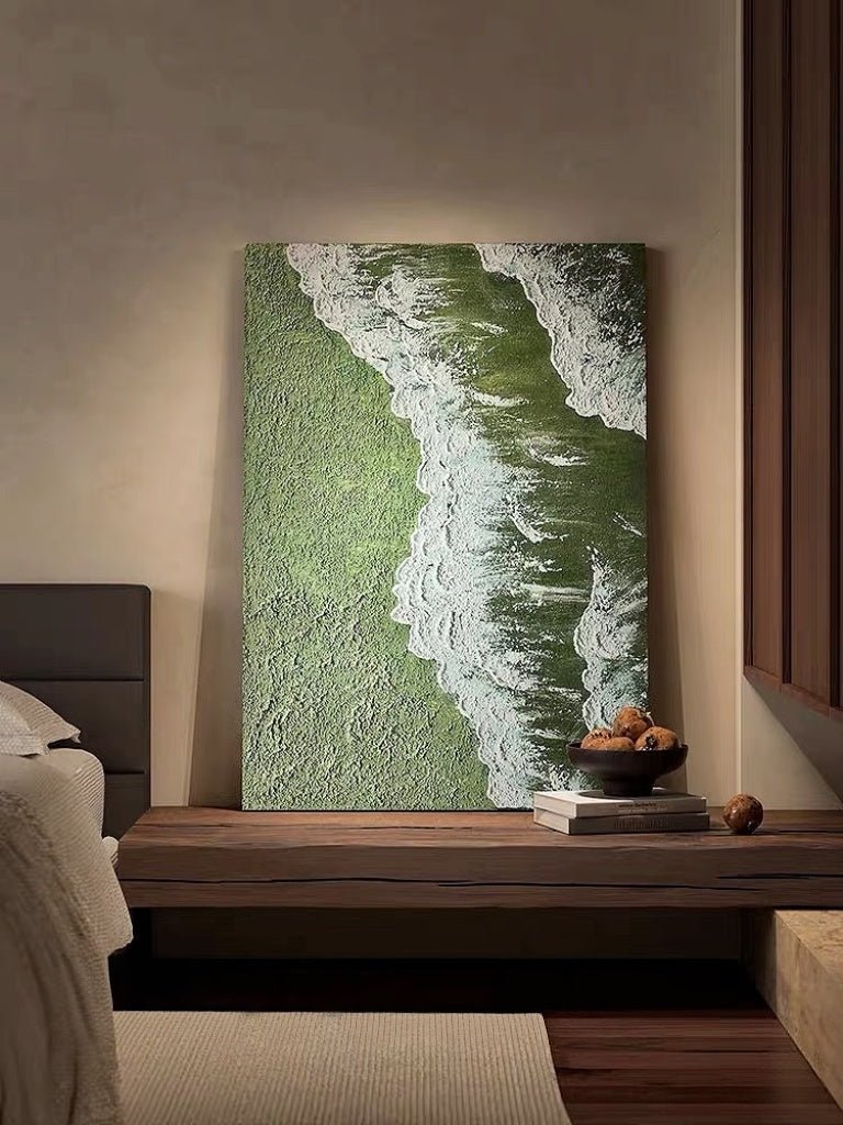 High-relief 3D textured painting showing white sculpted seafoam splashing over a deep forest green background in a gold frame.