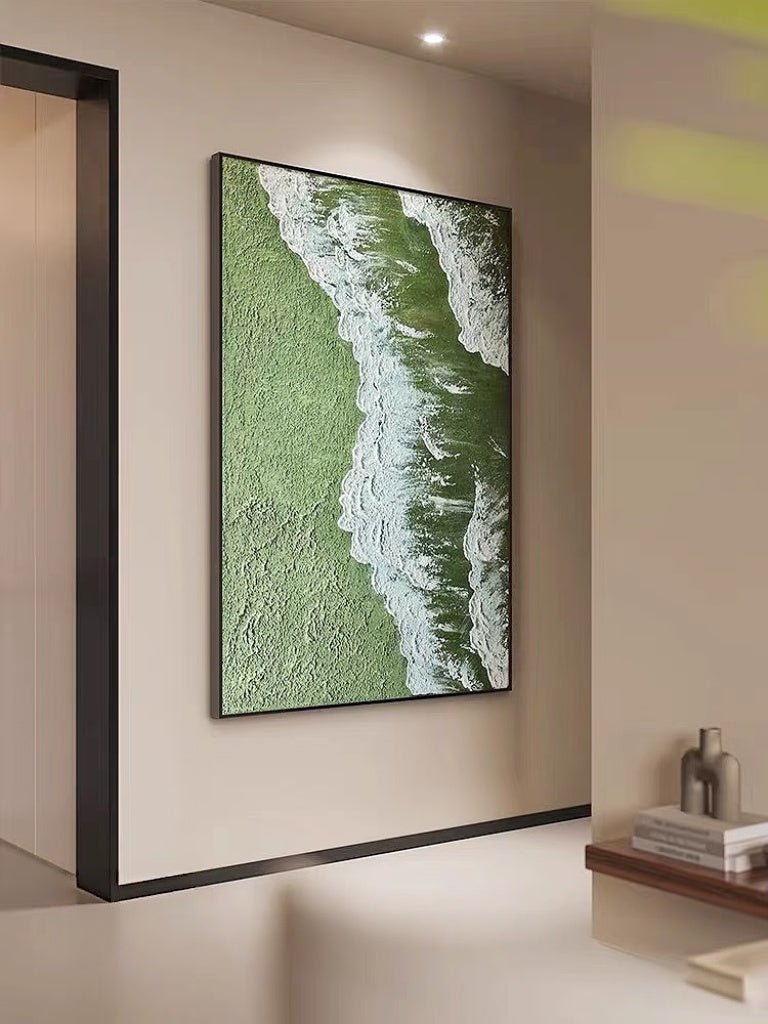 High-relief 3D textured painting showing white sculpted seafoam splashing over a deep forest green background in a gold frame.