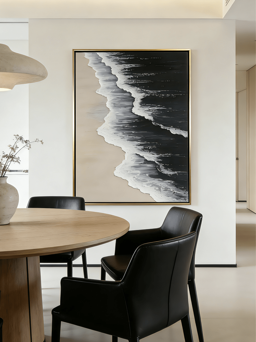 Large vertical hand-painted black ocean painting with heavy 3D white foam texture and beige sand by Leo Liang in a modern minimalist interior.