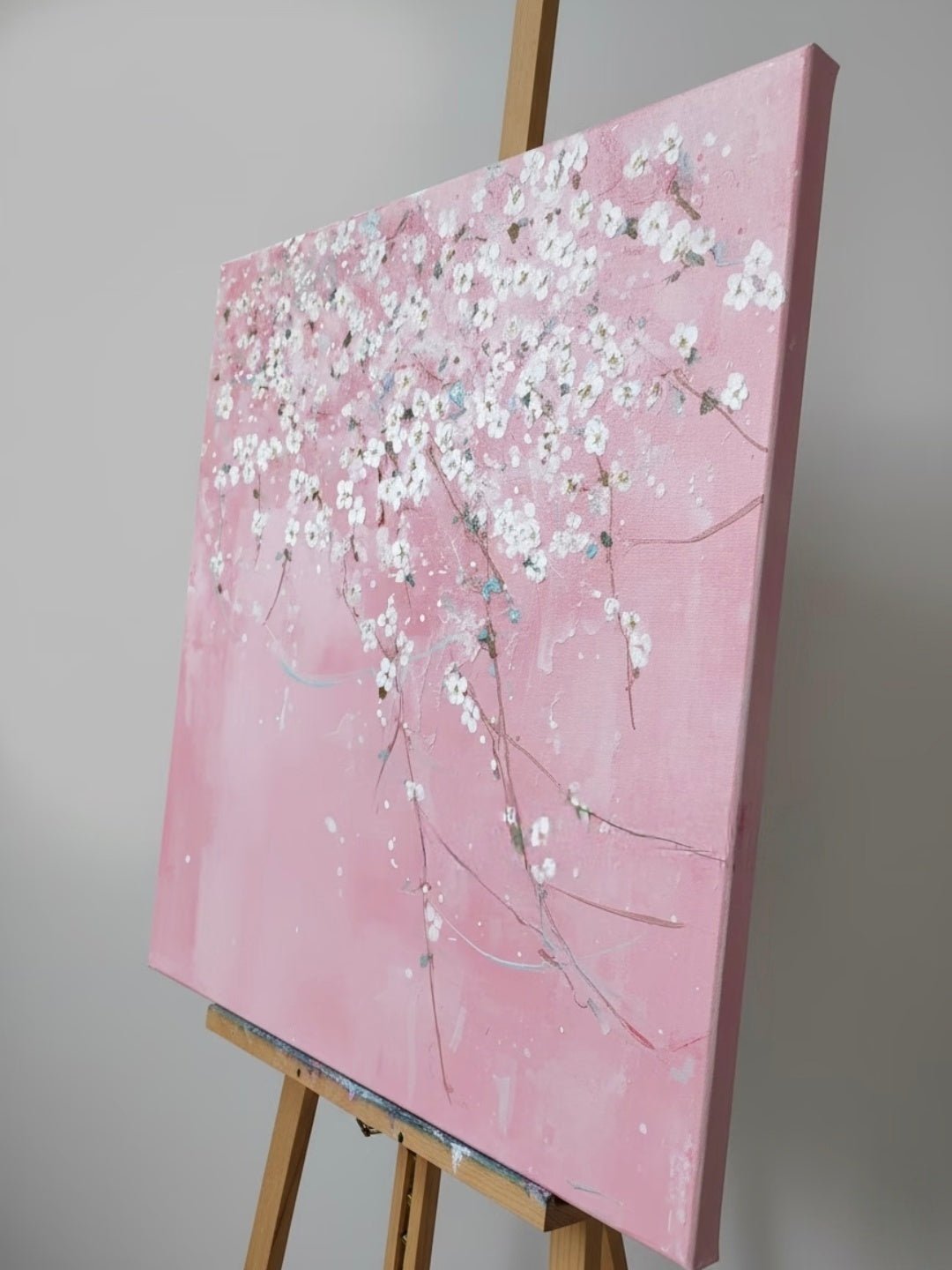 Close-up of large 3D textured abstract painting showing heavy white and taupe impasto ridges on canvas in a luxury living room.