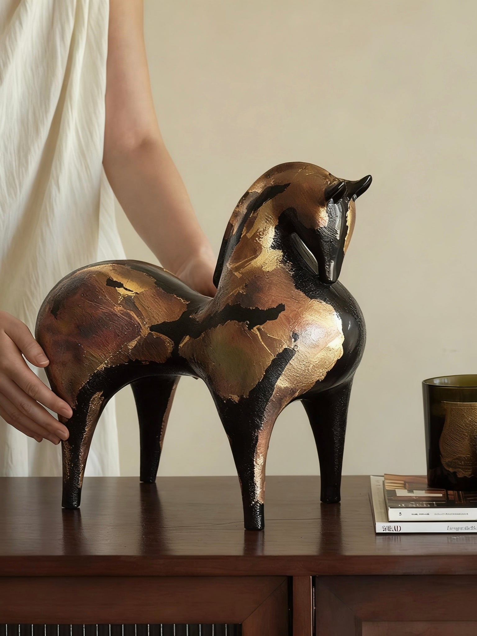 abstract horse sculpture with antique gold leaf finish on black resin, modern equestrian art for luxury home decor.