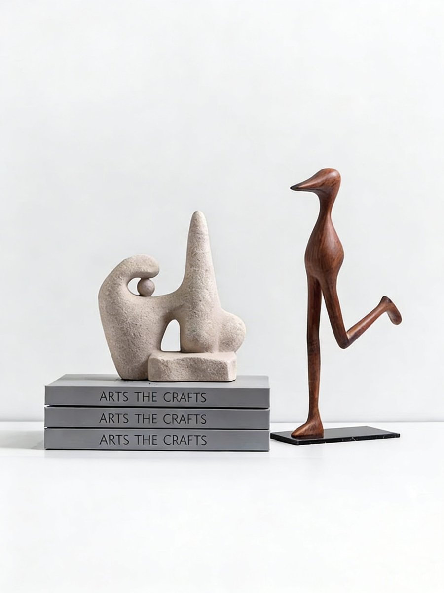 abstract biomorphic resin sculptures, sandstone texture stone art and wood finish running bird figurine on a bookshelf.