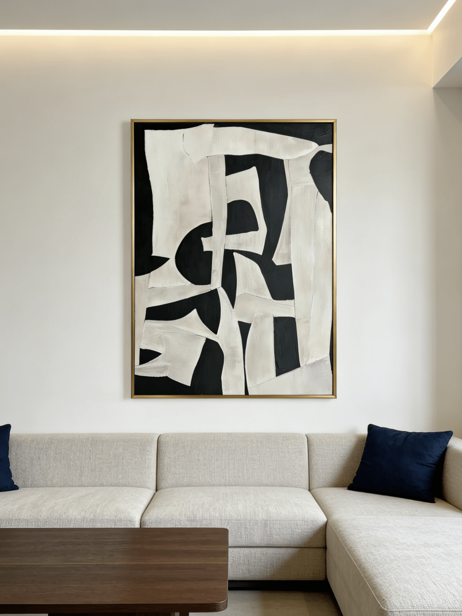 Large vertical hand-painted abstract painting with bold black and white geometric shapes and heavy impasto texture by Seraphina Rose in a modern luxury living room.