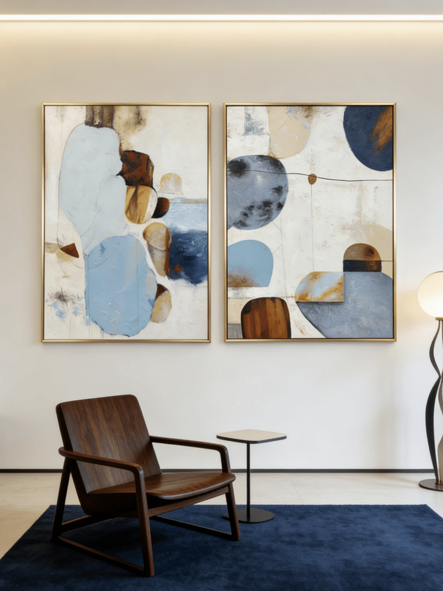 Large 2-piece hand-painted abstract diptych with organic blue and terracotta shapes and heavy texture by Seraphina Rose in a modern coastal living room.