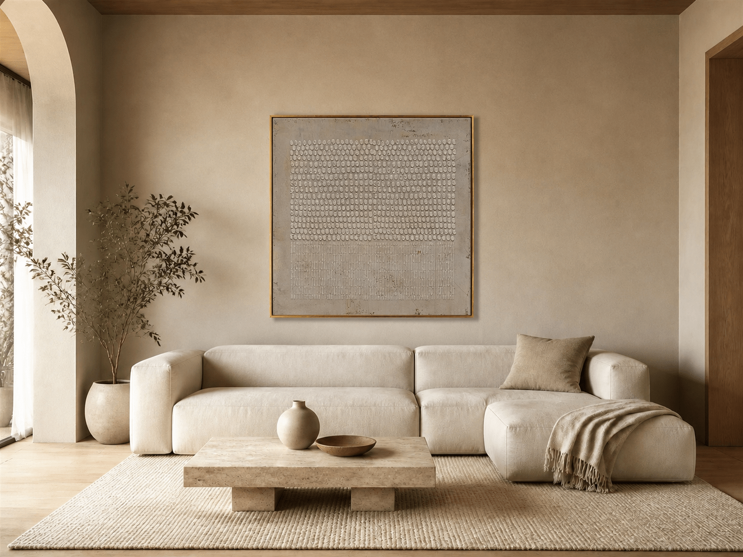 Beige geometric dotted-relief wall art above a cream sofa