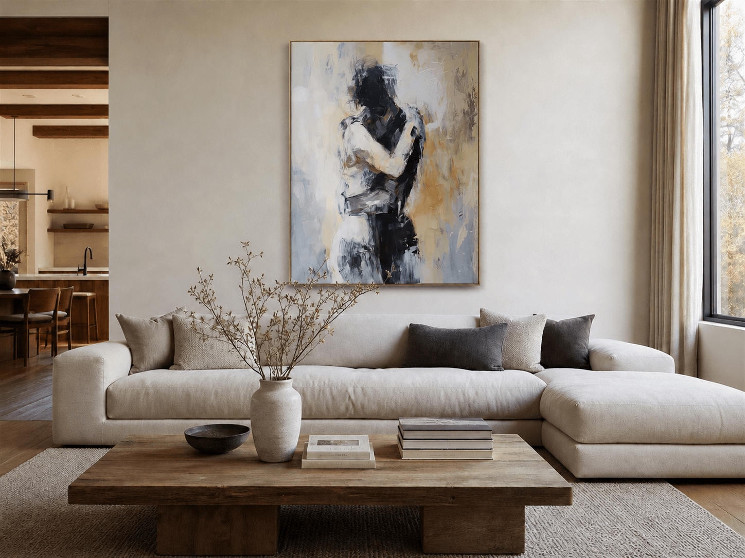 Abstract couple wall art above a white sectional in a neutral living room