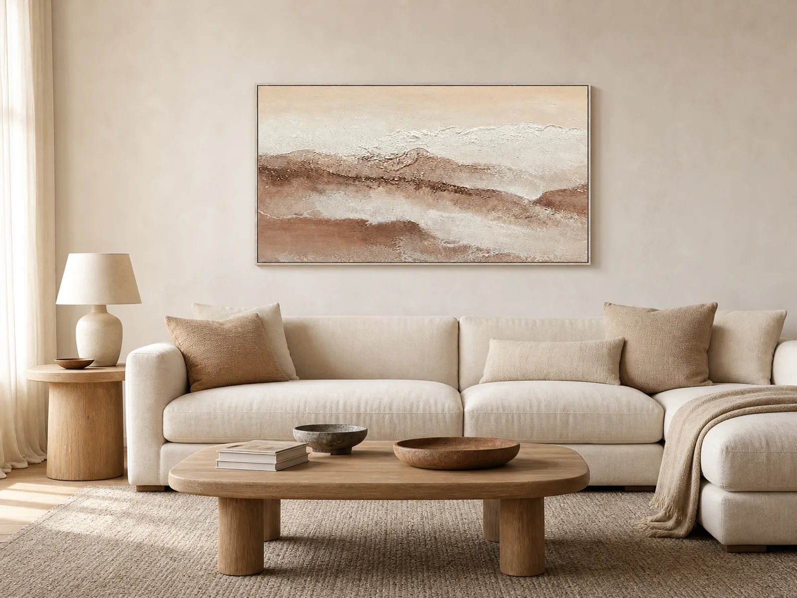 Neutral panoramic landscape wall art above a warm modern living room sofa