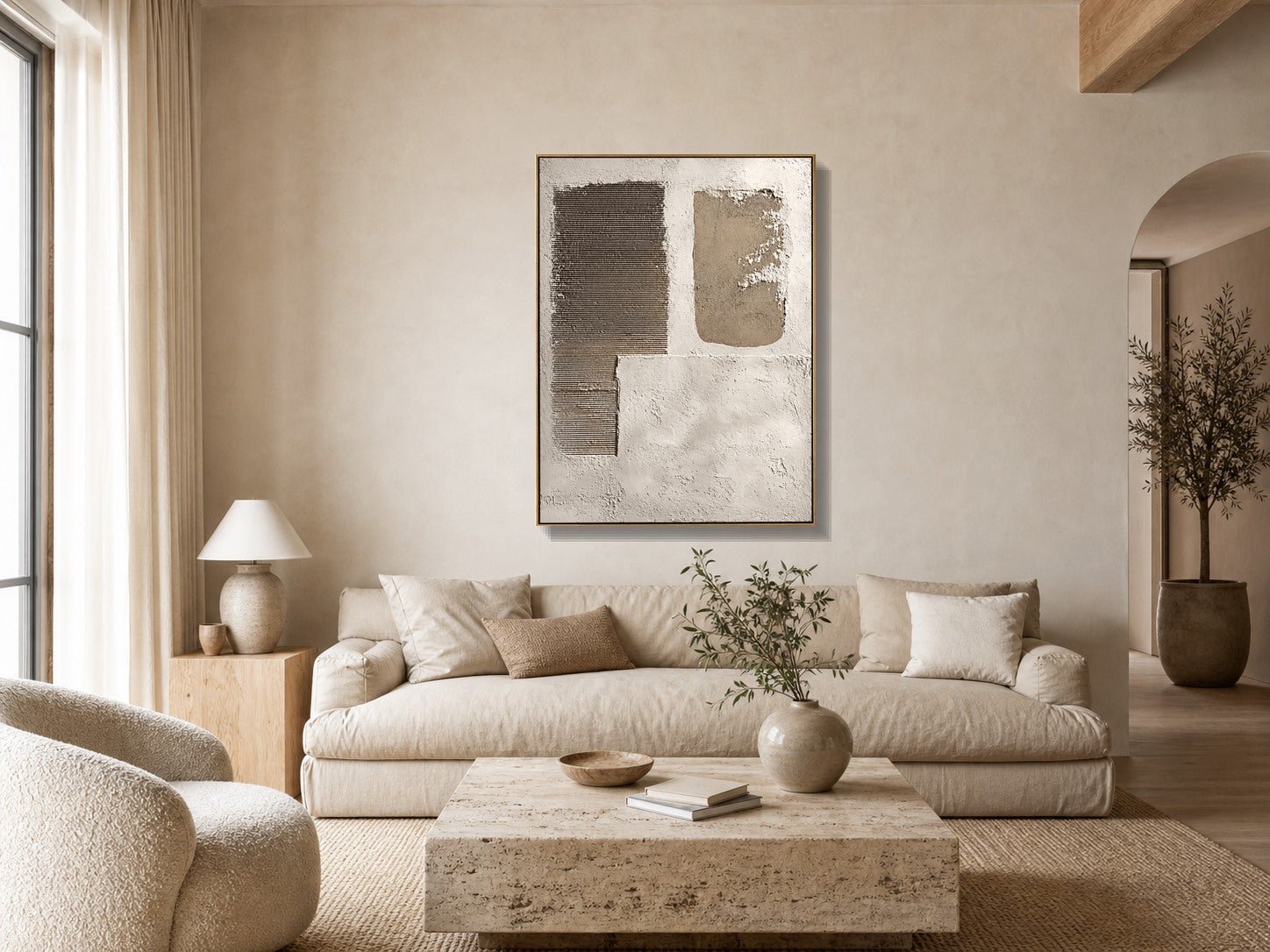 Neutral textured geometric wall art above a beige sofa in a warm minimalist living room