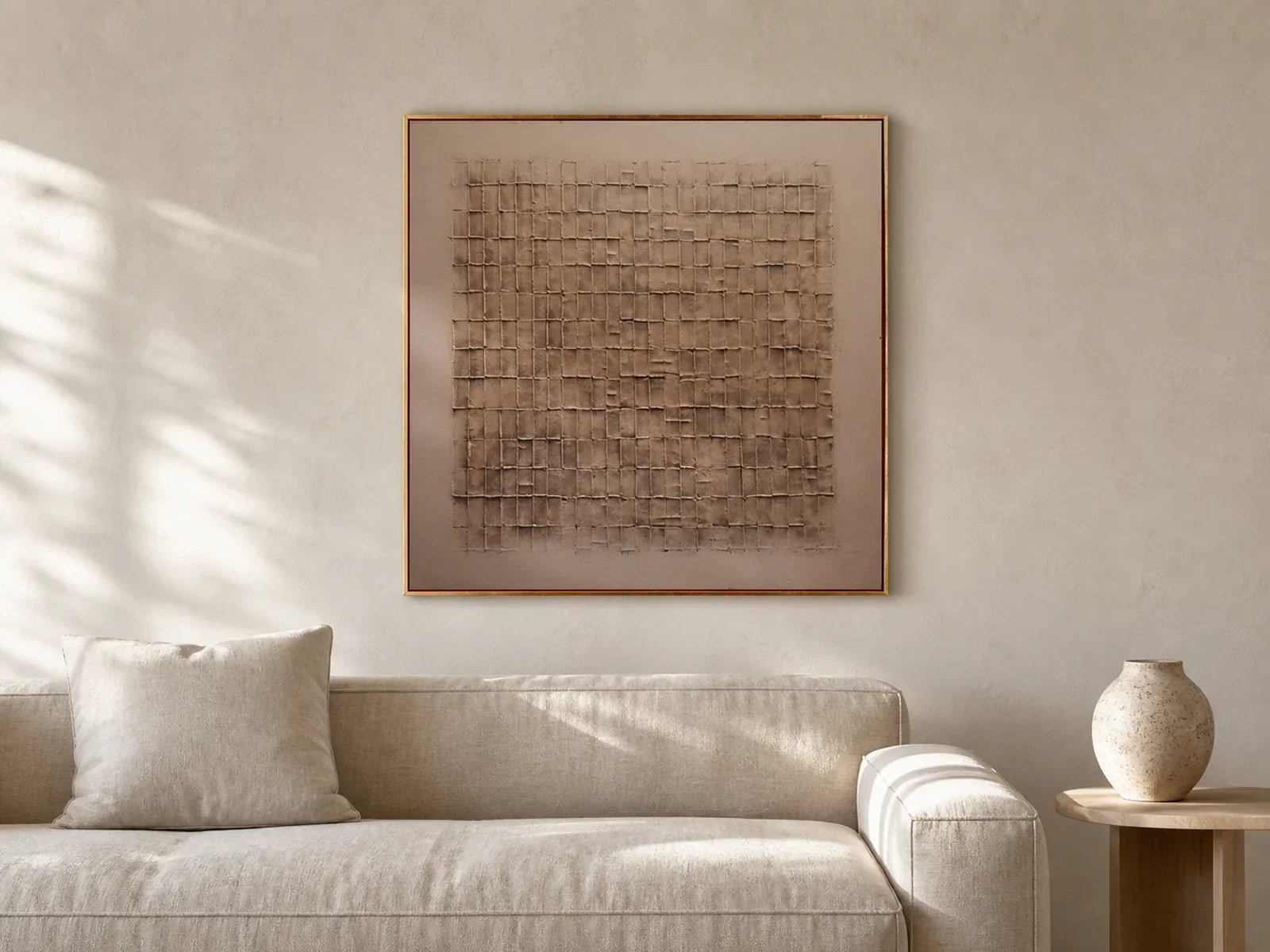 Hand-painted textured wall art in a neutral living room with side light revealing raised surface detail