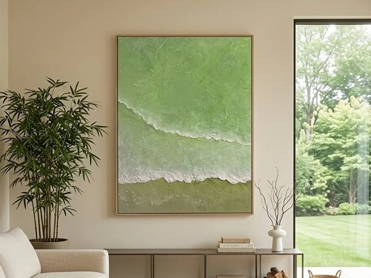 Large hand-painted sage green textured wall art in a sunlit neutral living room with garden views.