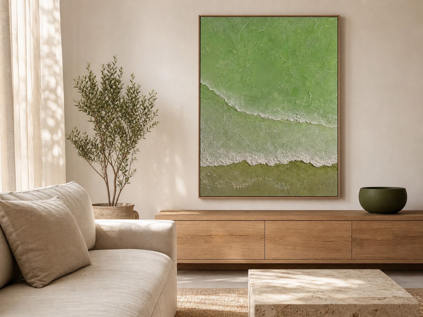 Sage green textured ocean wall art above an oak console in a modern coastal living room