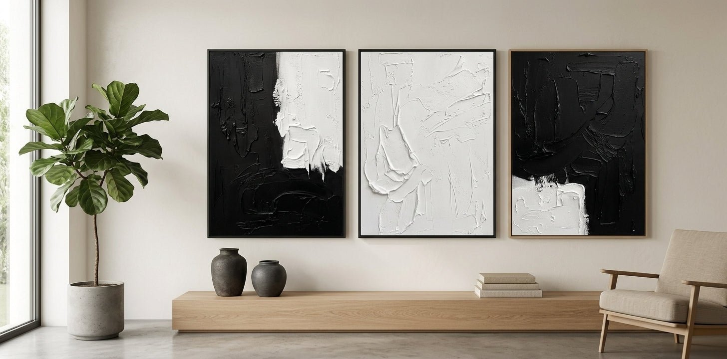 Modern minimalist living room featuring a grand monochrome textured painting framed in sleek black matte.
