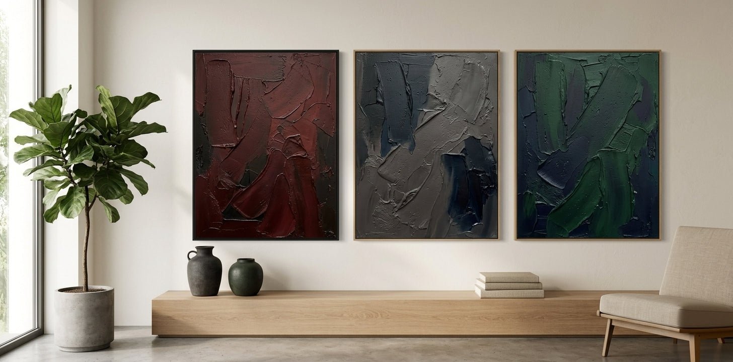 Moody gallery-style living room featuring a grand vertical heritage-toned abstract painting above a leather sofa.