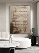 Large hand-painted modern abstract canvas painting with 3D plaster geometric grid texture in cement grey and rust brown by Eliot Vermeer for modern living room.
