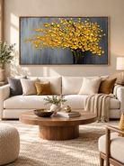 Textured golden tree canvas painting displayed above a sofa in a sophisticated modern neutral living room.