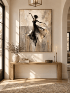 Modern abstract ballerina wall art in black, beige and taupe tones displayed in a refined entryway.