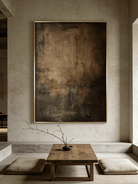 Close-up of vertical hand-painted 3D textured abstract painting with amber, brown, and charcoal impasto layers by Akari Kobayashi in a gold frame.