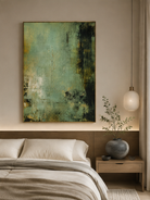 Muted green abstract wall art displayed above the bed in a calm contemporary neutral bedroom