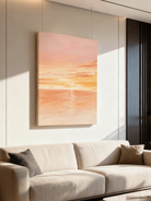 Sunset seascape painting displayed in modern living room, showing coastal wall art in home decor setting