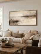 Wide abstract landscape wall art displayed above a neutral sofa