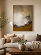 Earth-tone coastal wall art displayed above a neutral sofa in an organic modern living room