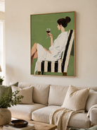 Sage green figurative wall art displayed in a modern neutral living room