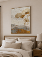 Cream and gold floral canvas styled above a bed in a sophisticated neutral bedroom