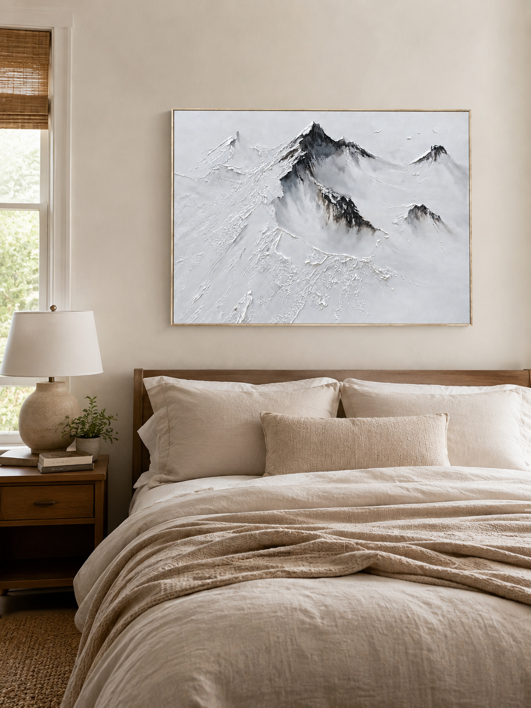 Minimalist snow mountain wall art displayed above a bed in a calm neutral bedroom