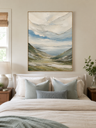 Sage green mountain landscape wall art displayed above a bed in a calm modern bedroom
