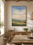 Impasto countryside landscape painting displayed in a warm open-plan dining room